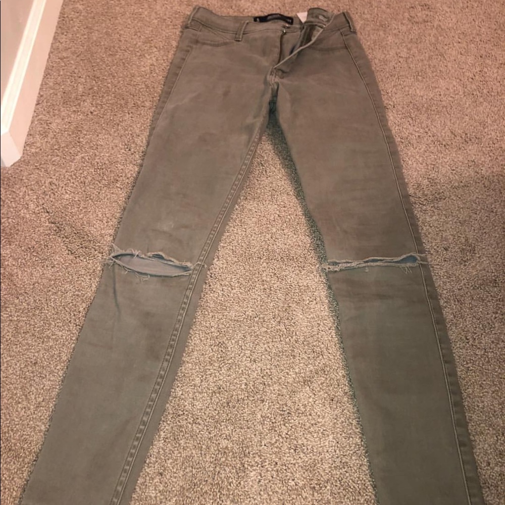 army green skinny jeans with rips in knees